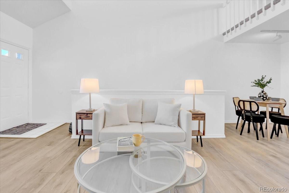 3066 West Prentice Avenue, Unit G Littleton, CO 80123 - Photo 9 of 18 a living room with furniture and a table