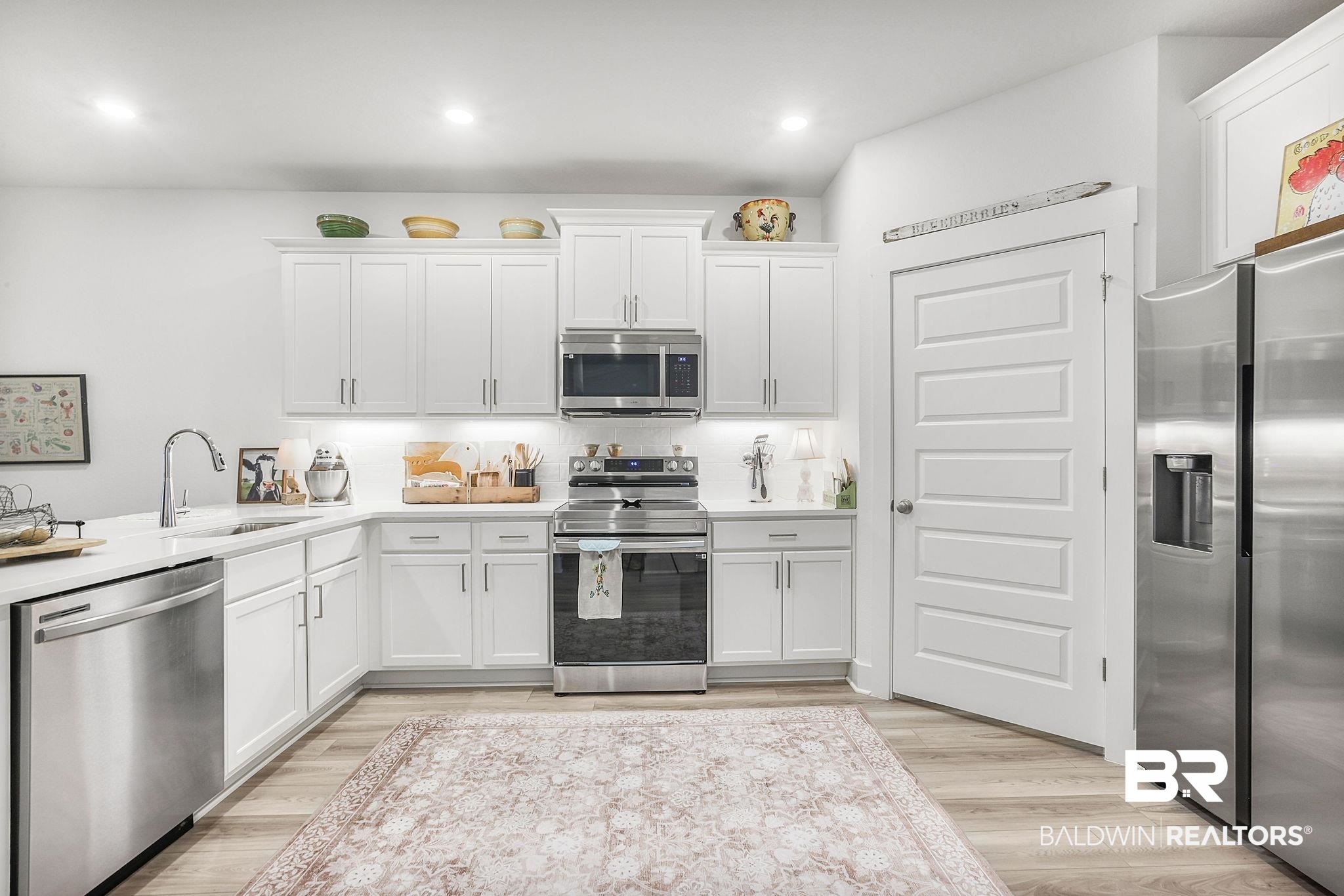 9901 Weller Cove Foley, AL 36535 - Photo 13 of 23 Kitchen featuring stainless steel appliances, light countertops, white cabinetry, and recessed lighting