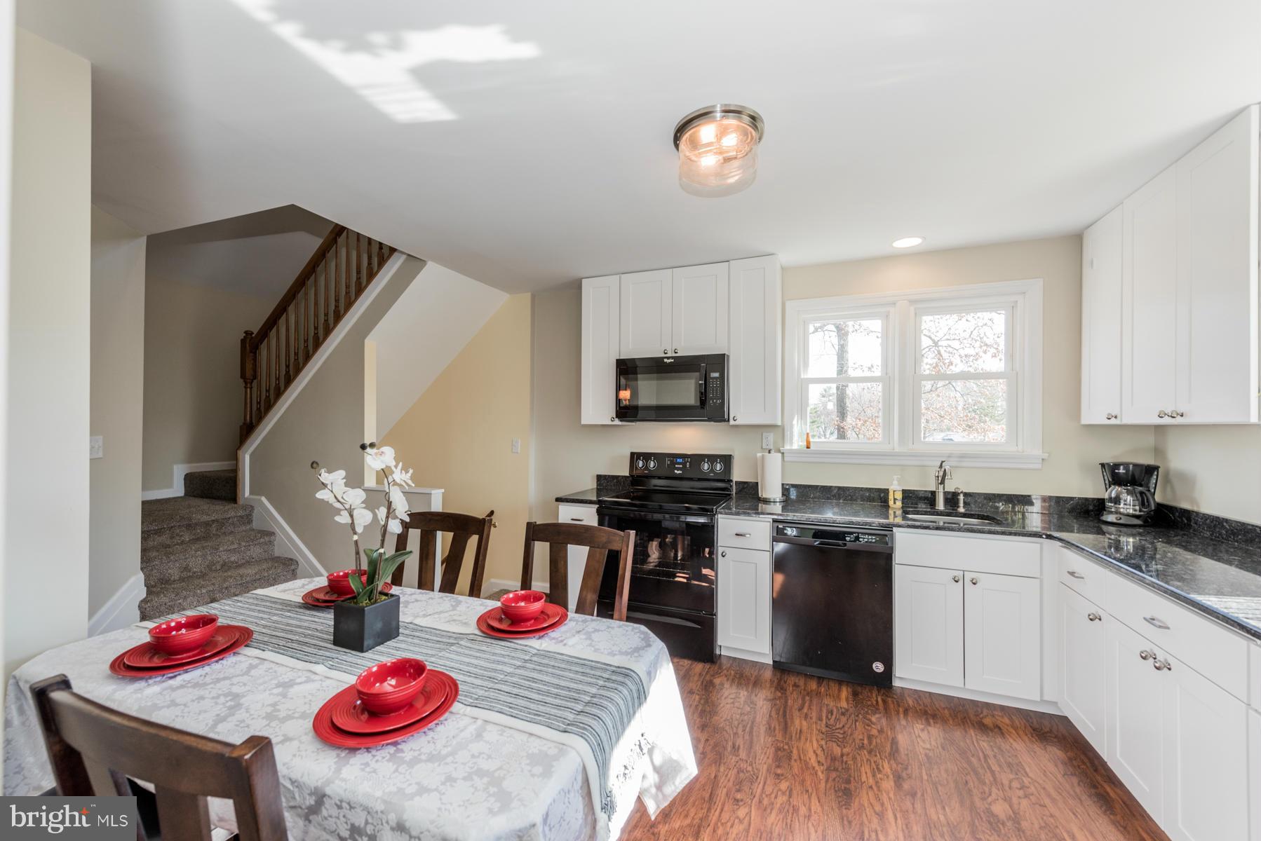 15103 Parrish Road Upperco, MD 21155 - Photo 11 of 26 a kitchen with a sink stove top oven and microwave