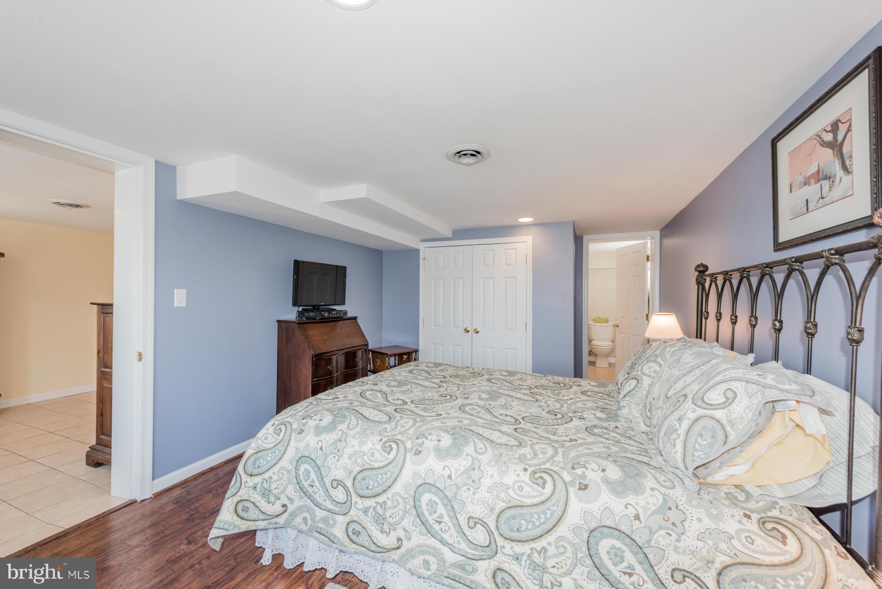 15103 Parrish Road Upperco, MD 21155 - Photo 13 of 26 a bedroom with a bed and a television