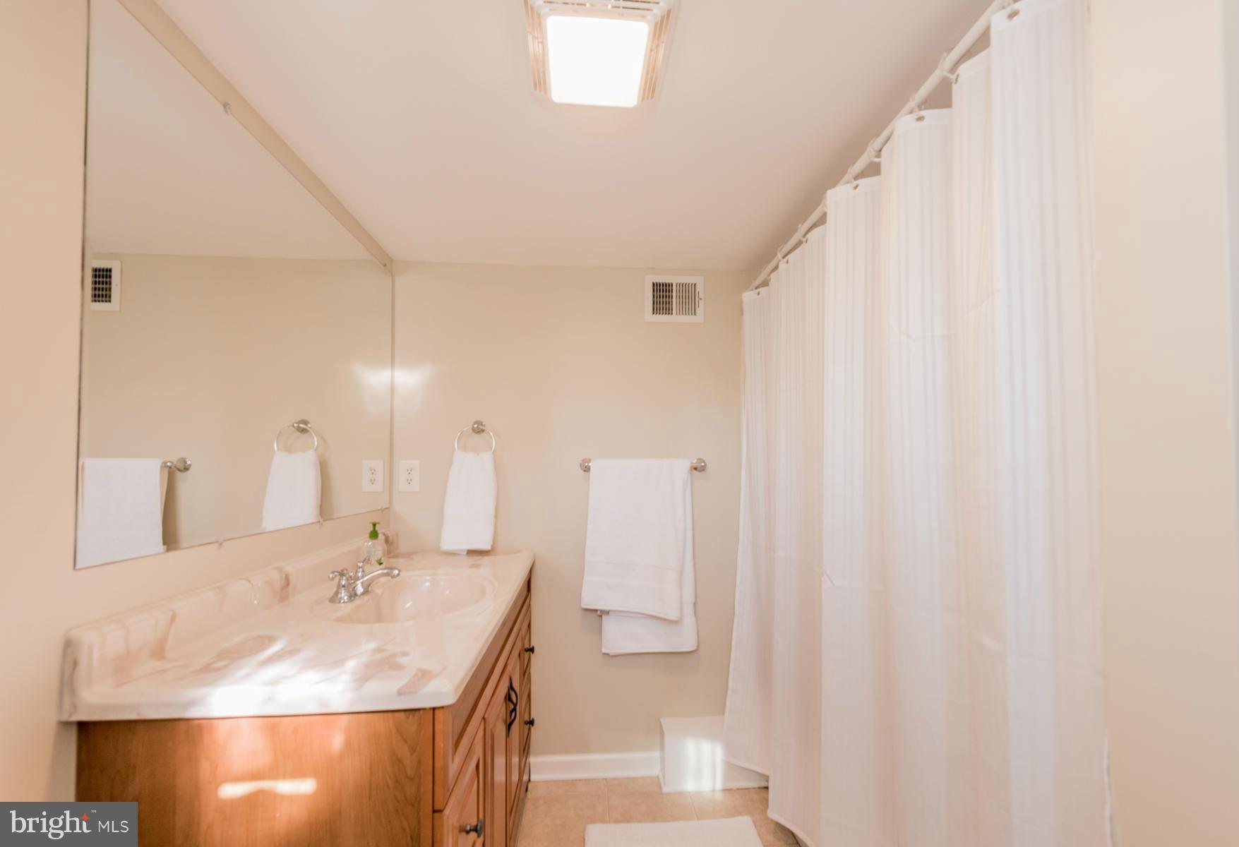 15103 Parrish Road Upperco, MD 21155 - Photo 14 of 26 a bathroom with a sink and a mirror