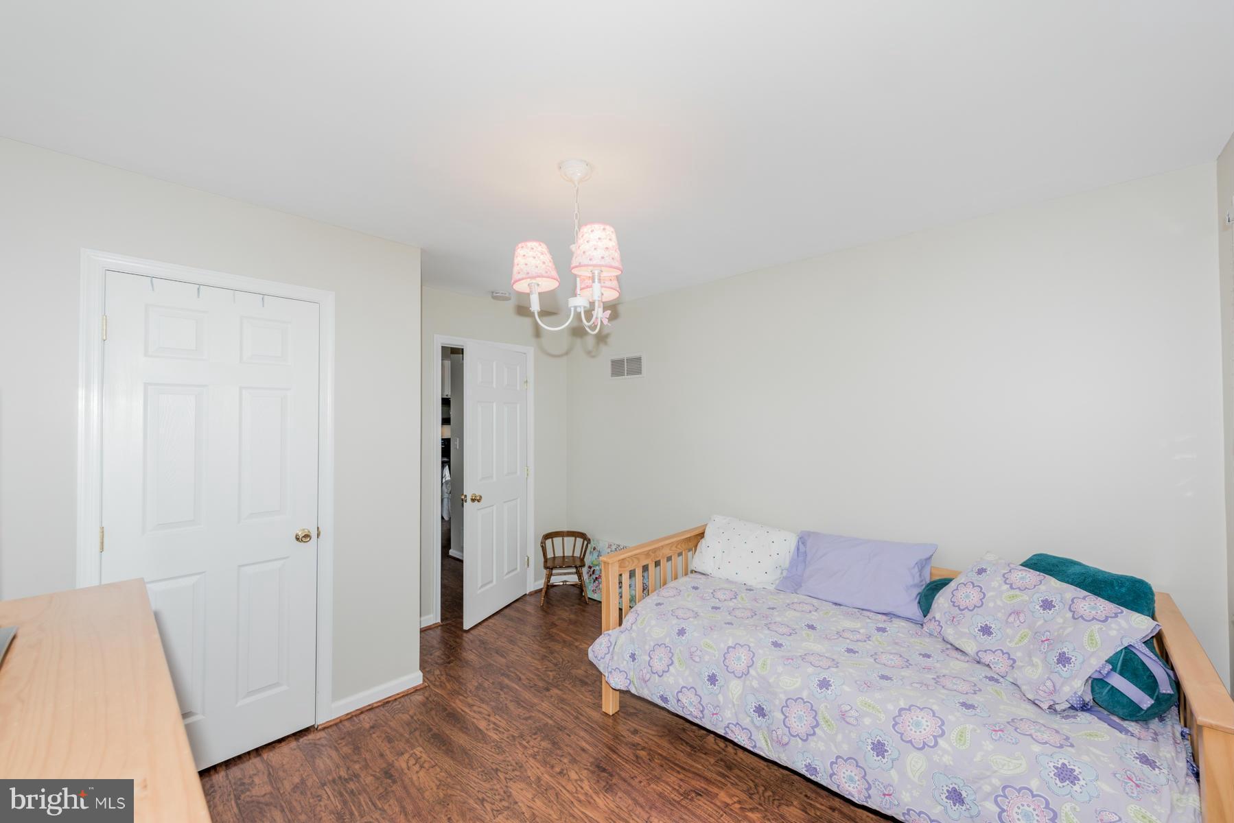 15103 Parrish Road Upperco, MD 21155 - Photo 19 of 26 a bedroom with a bed and a chandelier