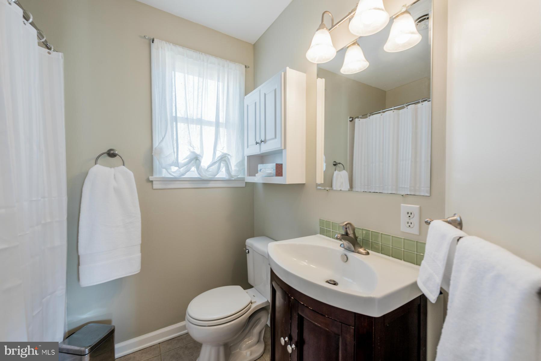 15103 Parrish Road Upperco, MD 21155 - Photo 20 of 26 a bathroom with a sink and a mirror