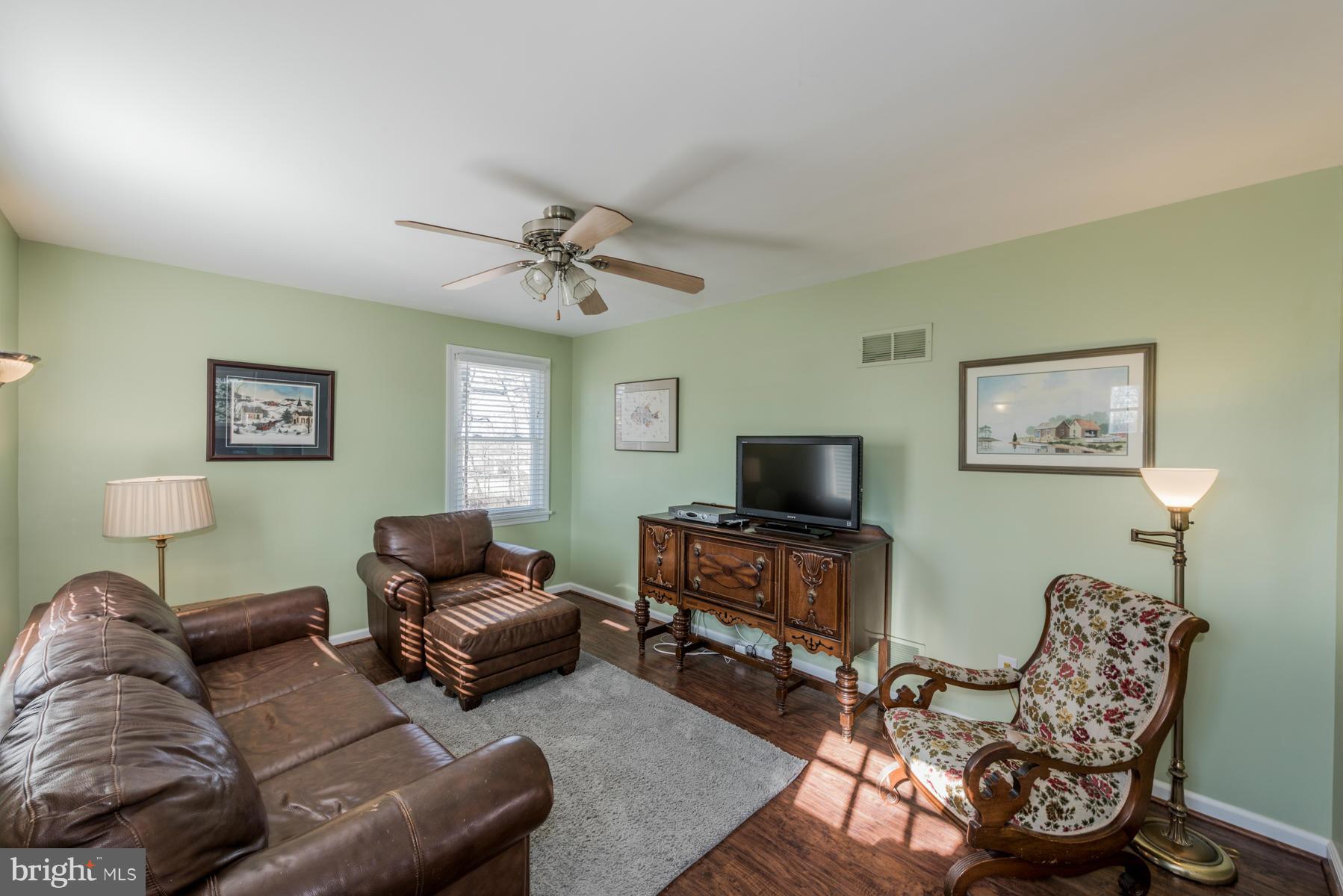 15103 Parrish Road Upperco, MD 21155 - Photo 5 of 26 a living room with furniture a ceiling fan and a window