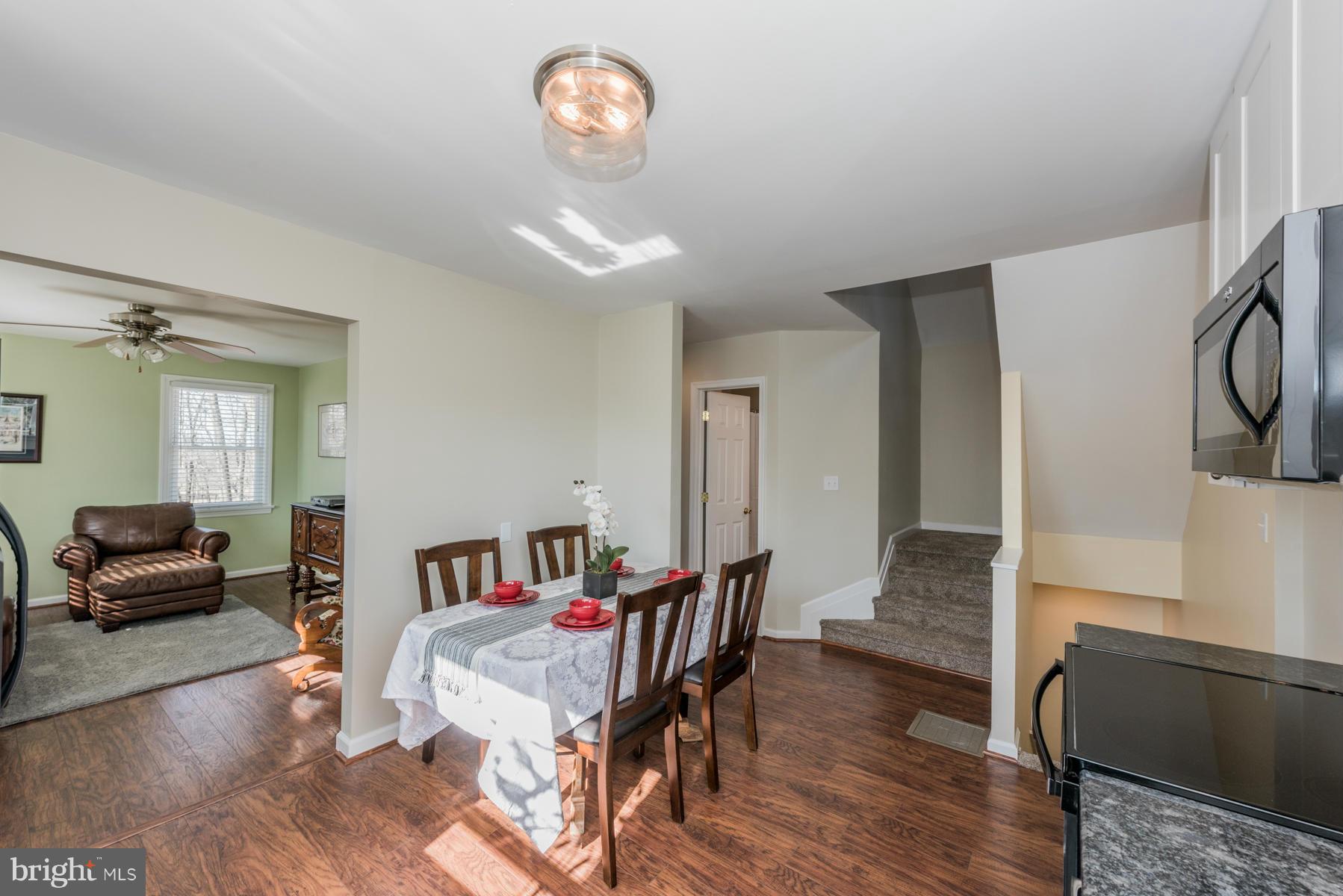 15103 Parrish Road Upperco, MD 21155 - Photo 6 of 26 a dining room with furniture a chandelier and wooden floor