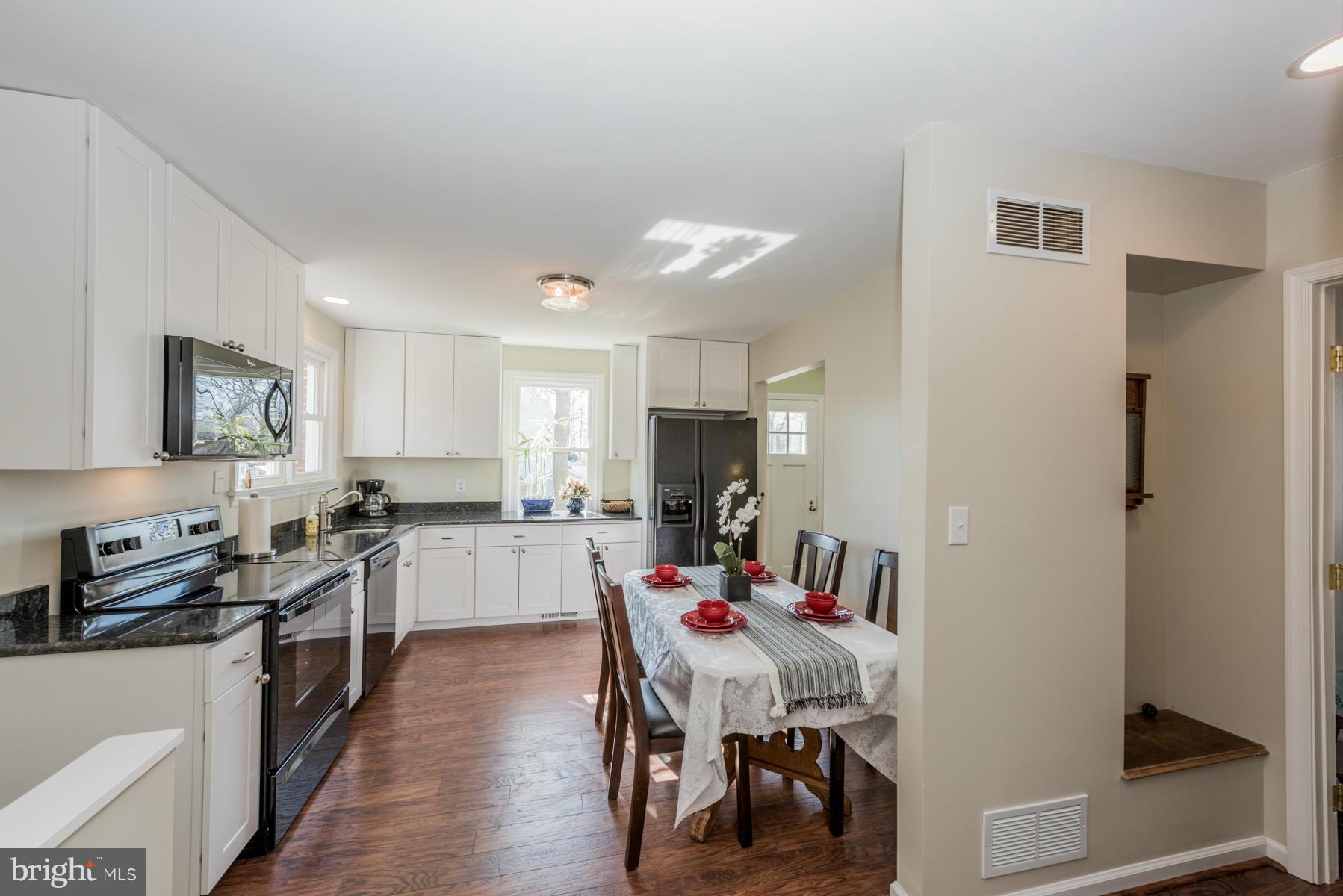 15103 Parrish Road Upperco, MD 21155 - Photo 8 of 26 a large kitchen with a table and chairs in it