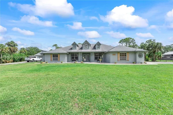 a front view of house with yard and green space