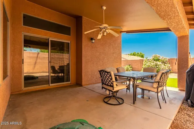 a dining room with furniture and a potted plant