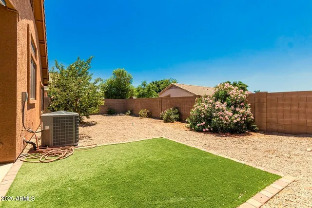 a view of a backyard with potted plants and a fountain