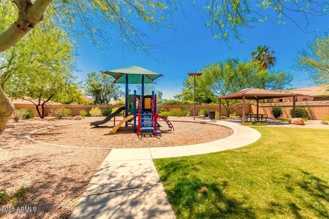 a view of a swimming pool with a lawn chairs under an umbrella