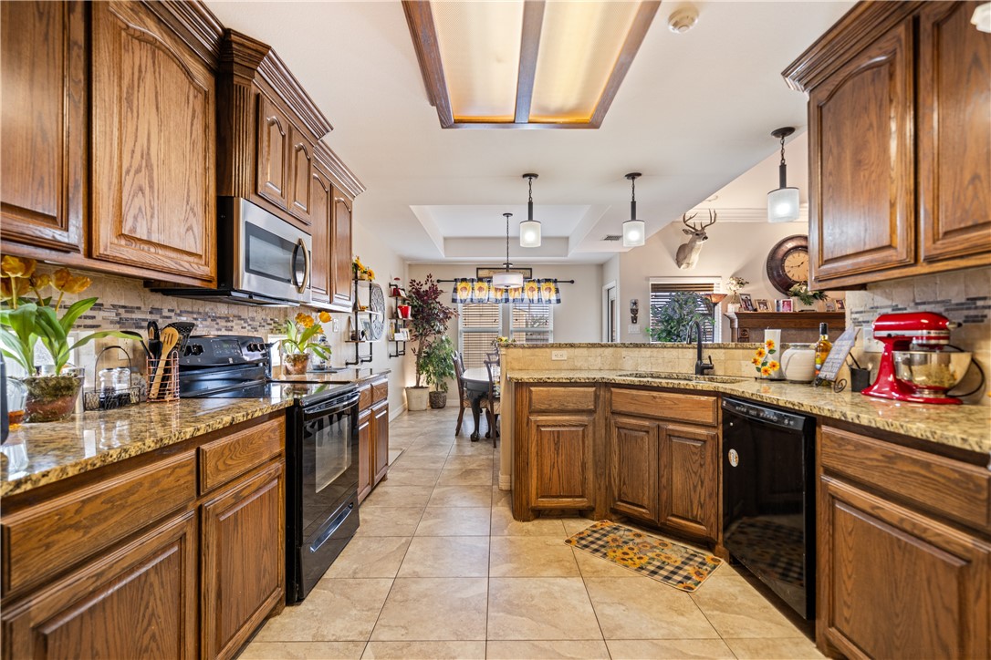2602 Retta Drive Corpus Christi, TX 78418 - Photo 15 of 32 a kitchen with stainless steel appliances granite countertop a sink and cabinets