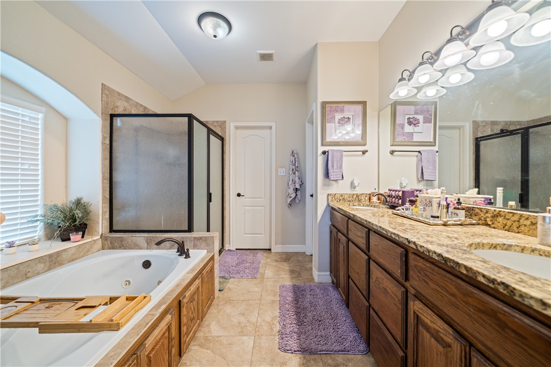 2602 Retta Drive Corpus Christi, TX 78418 - Photo 19 of 32 a spacious bathroom with a granite countertop tub sink and mirror