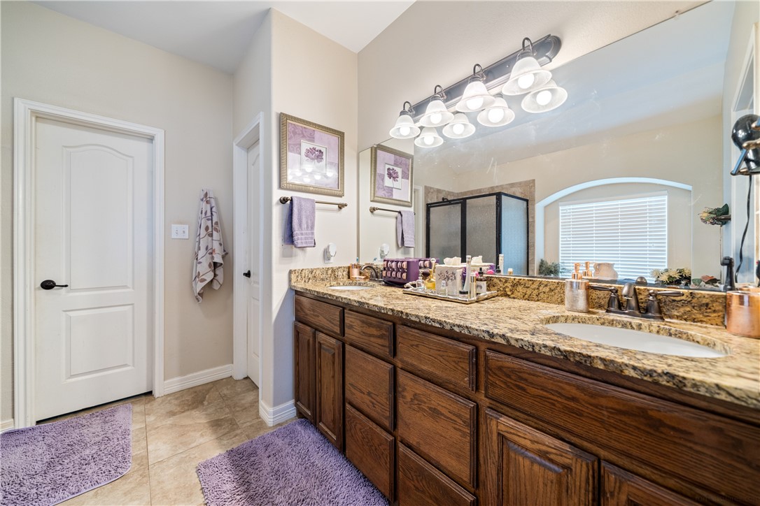 2602 Retta Drive Corpus Christi, TX 78418 - Photo 20 of 32 a spacious bathroom with a granite countertop sink a mirror and shower