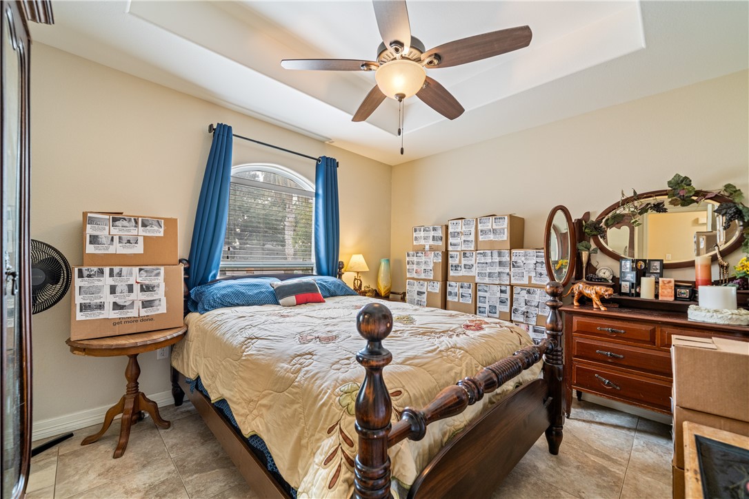 2602 Retta Drive Corpus Christi, TX 78418 - Photo 23 of 32 a bedroom with a bed a dresser and next to a window