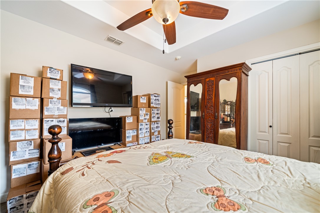 2602 Retta Drive Corpus Christi, TX 78418 - Photo 24 of 32 a bedroom with a bed and a flat screen tv