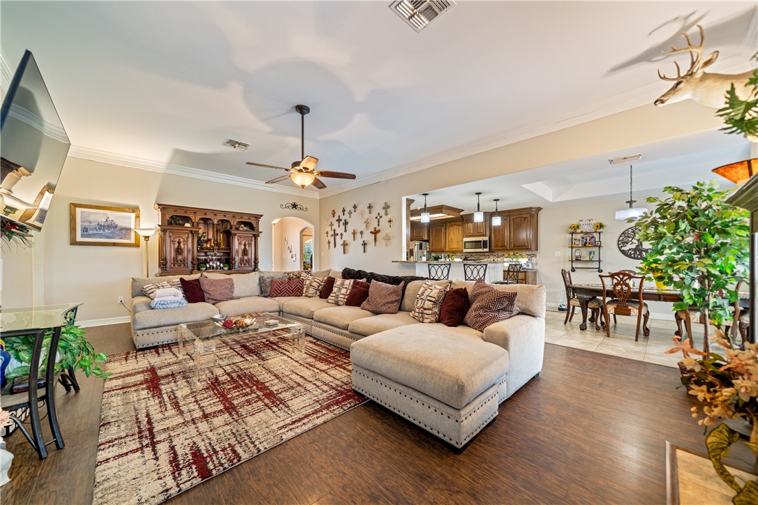 2602 Retta Drive Corpus Christi, TX 78418 - Photo 9 of 32 a living room with furniture kitchen view and a chandelier
