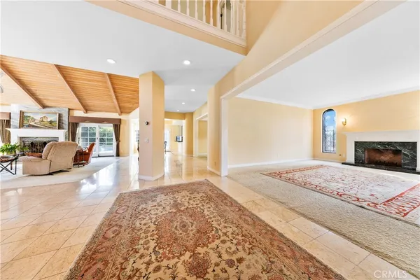 a view of hallway with furniture and a large window