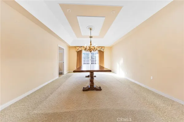 a kitchen with stainless steel appliances granite countertop a refrigerator a stove and white cabinets with wooden floor