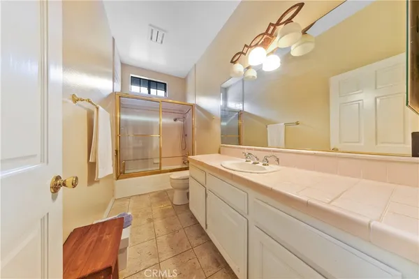 a view of a big room with windows and chandelier