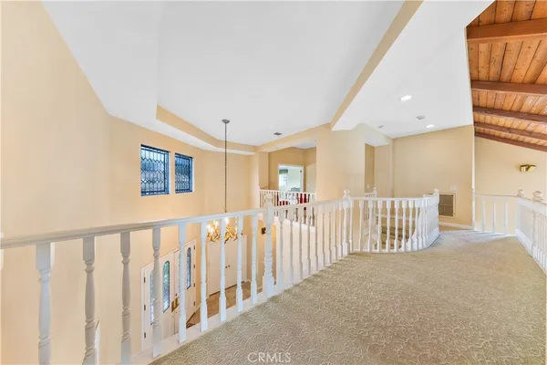 a spacious bedroom with a bed and a flat screen television