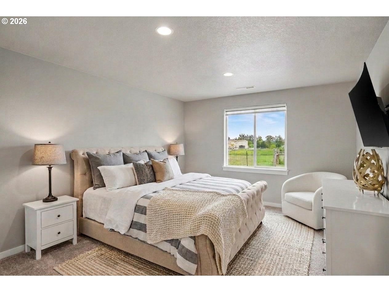 11862 Steinkamp Road Southeast Aumsville, OR 97325 - Photo 25 of 48 a bedroom with a bed and a flat screen tv