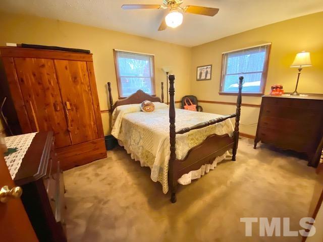 7008 Blalock Road Bahama, NC 27503 - Photo 9 of 15 a bed sitting in a bedroom next to a window