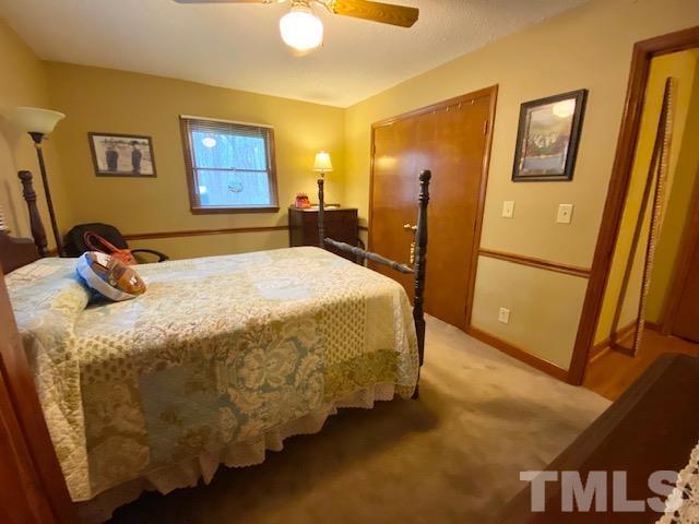 7008 Blalock Road Bahama, NC 27503 - Photo 10 of 15 a bedroom with a bed and a cabinets