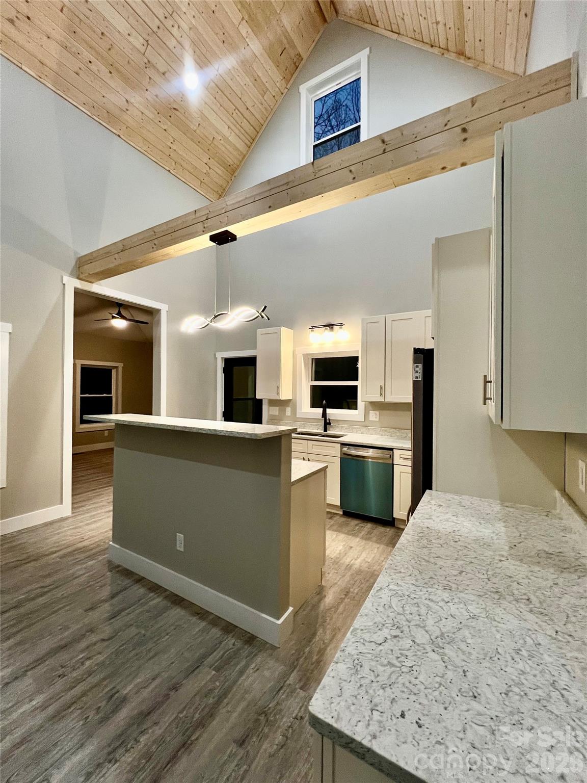 199 Clinchfield Gap Road Marion, NC 28752 - Photo 11 of 29 a kitchen with stainless steel appliances kitchen island granite countertop a stove a sink and a refrigerator