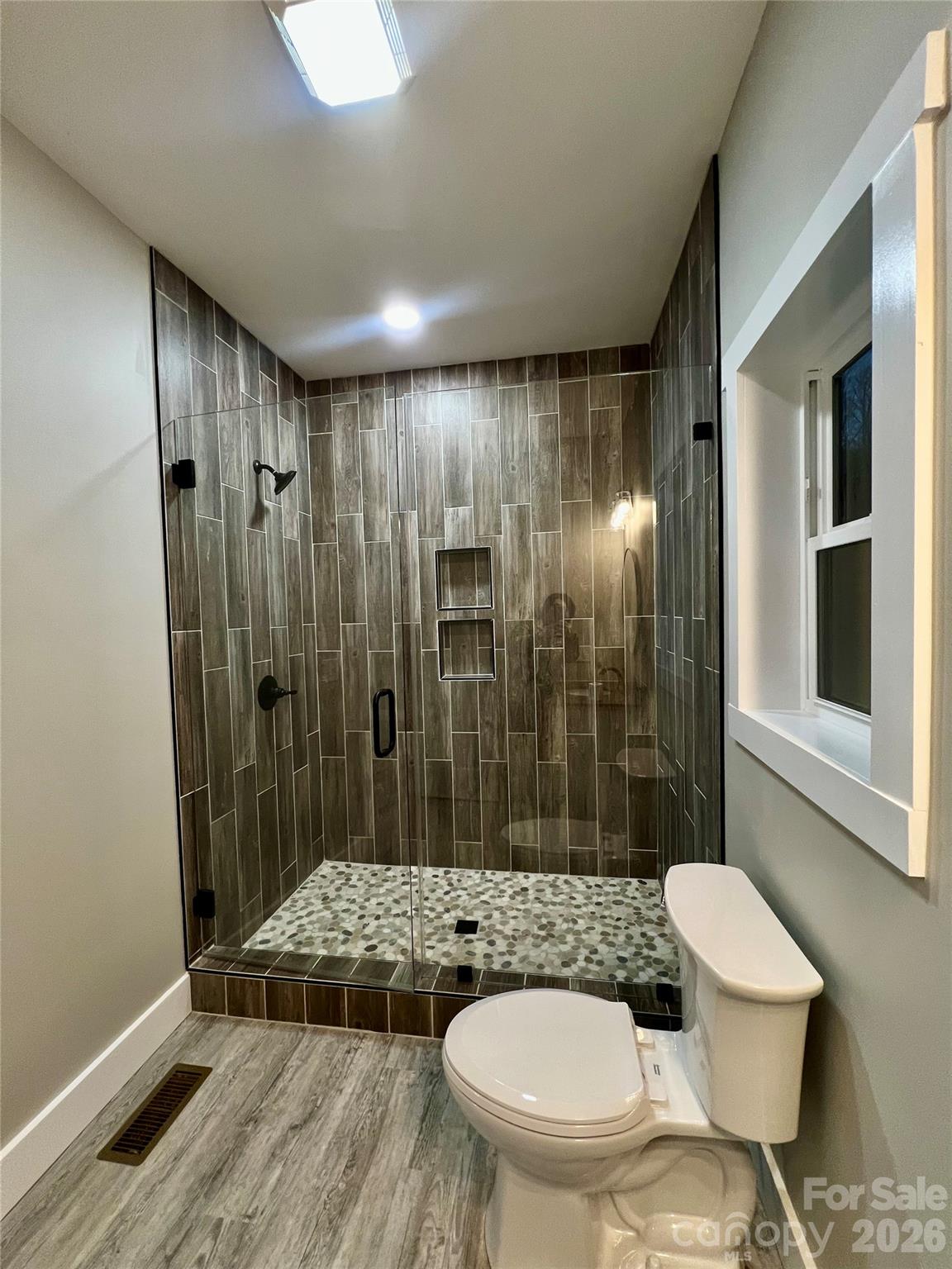 199 Clinchfield Gap Road Marion, NC 28752 - Photo 13 of 29 a bathroom with a sink toilet and shower