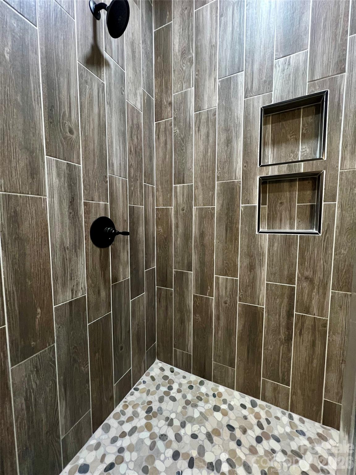 199 Clinchfield Gap Road Marion, NC 28752 - Photo 14 of 29 a bathroom with a shower and a sink