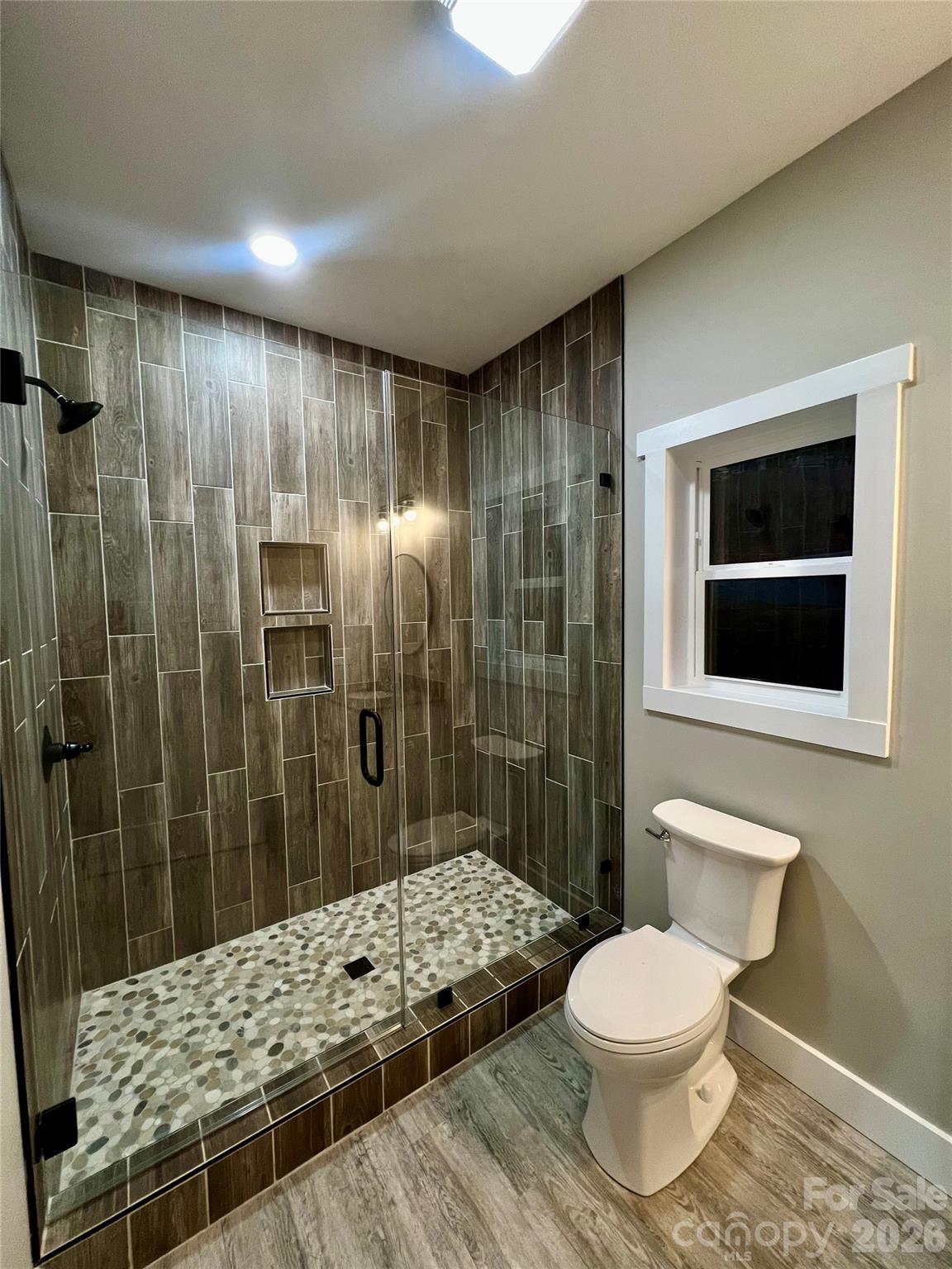 199 Clinchfield Gap Road Marion, NC 28752 - Photo 15 of 29 a bathroom with a sink toilet and shower