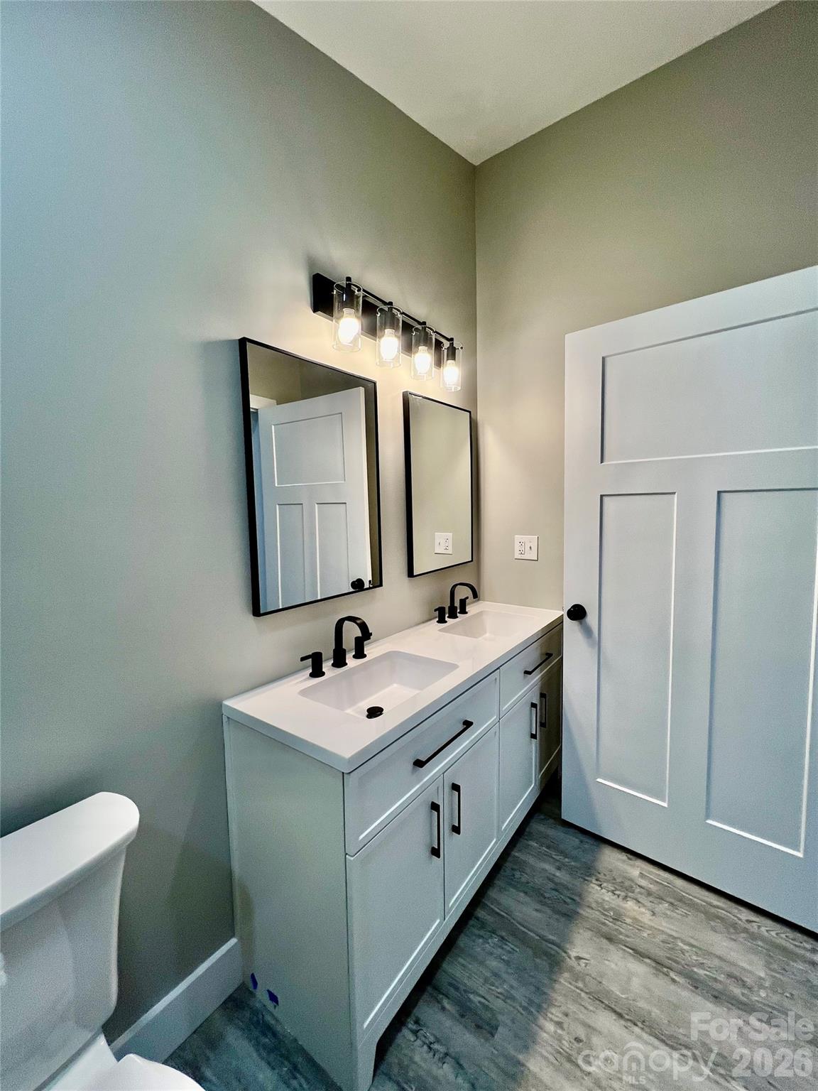 199 Clinchfield Gap Road Marion, NC 28752 - Photo 22 of 29 a bathroom with a double vanity sink and mirror