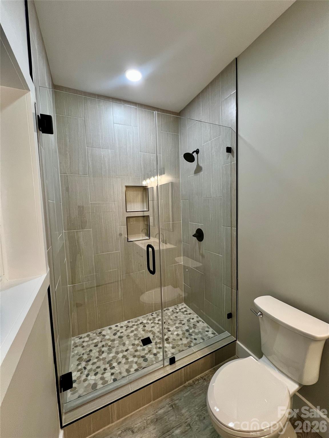 199 Clinchfield Gap Road Marion, NC 28752 - Photo 23 of 29 a bathroom with a toilet a shower a toilet and sink