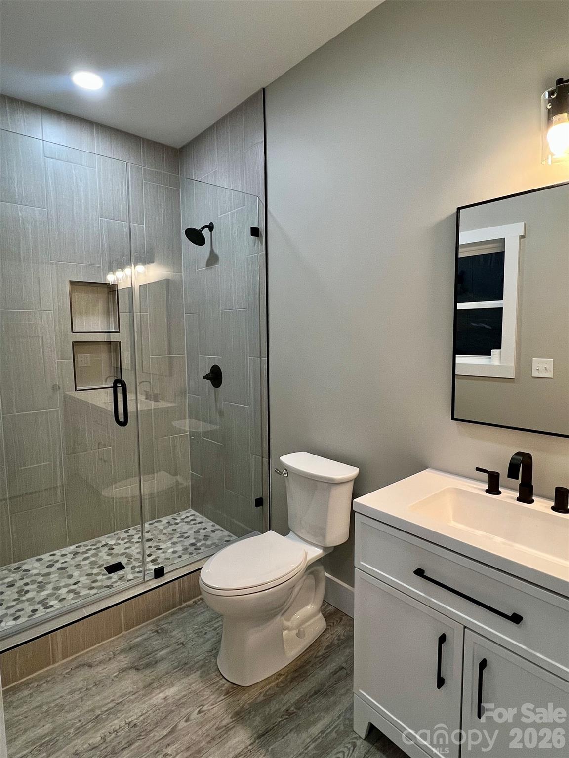 199 Clinchfield Gap Road Marion, NC 28752 - Photo 24 of 29 a bathroom with a sink a toilet and shower