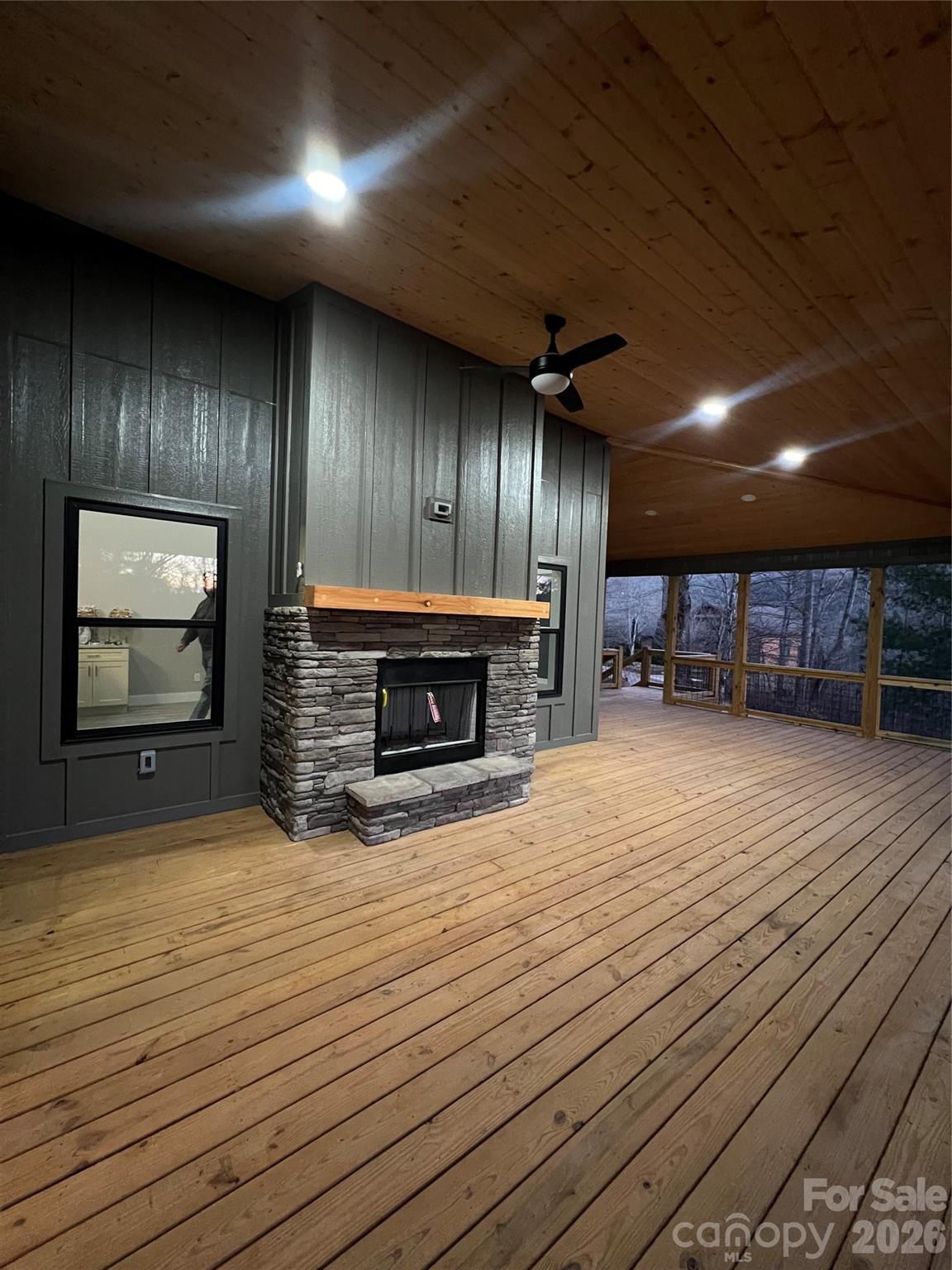 199 Clinchfield Gap Road Marion, NC 28752 - Photo 26 of 29 a view of an empty room with wooden floor fireplace and a window