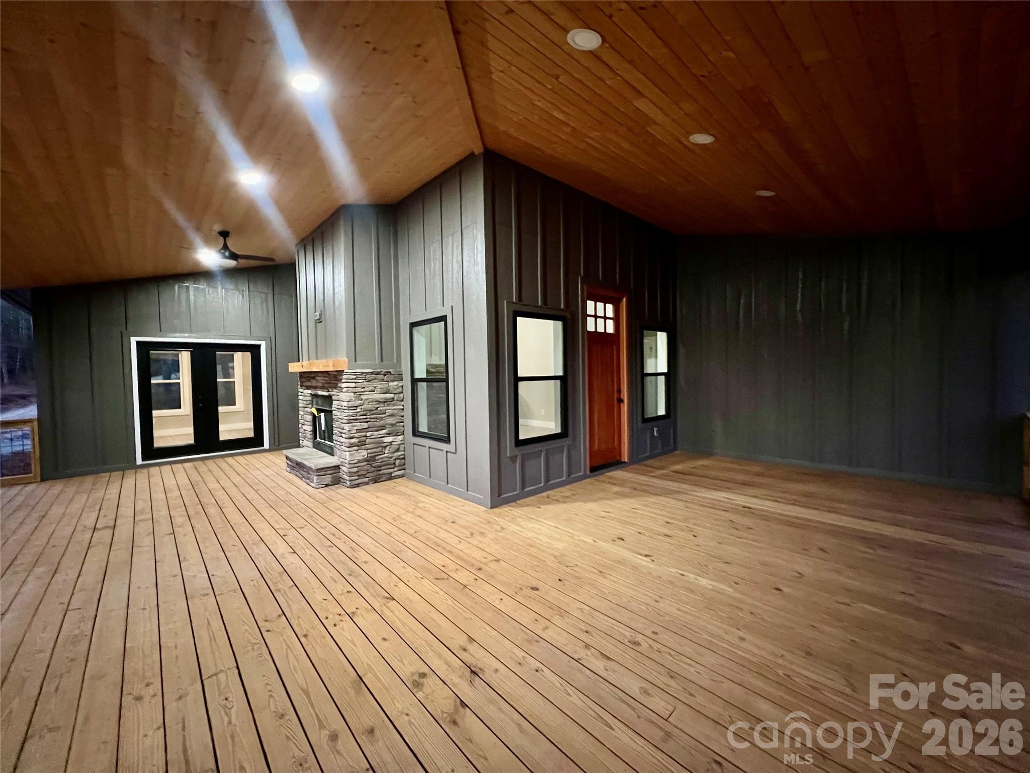 199 Clinchfield Gap Road Marion, NC 28752 - Photo 28 of 29 a view of an empty room with wooden floor and a kitchen