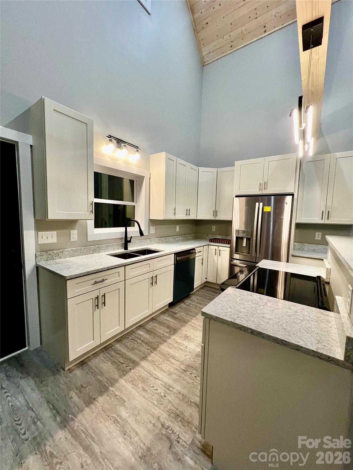 199 Clinchfield Gap Road Marion, NC 28752 - Photo 10 of 29 a kitchen with stainless steel appliances granite countertop a sink refrigerator and cabinets