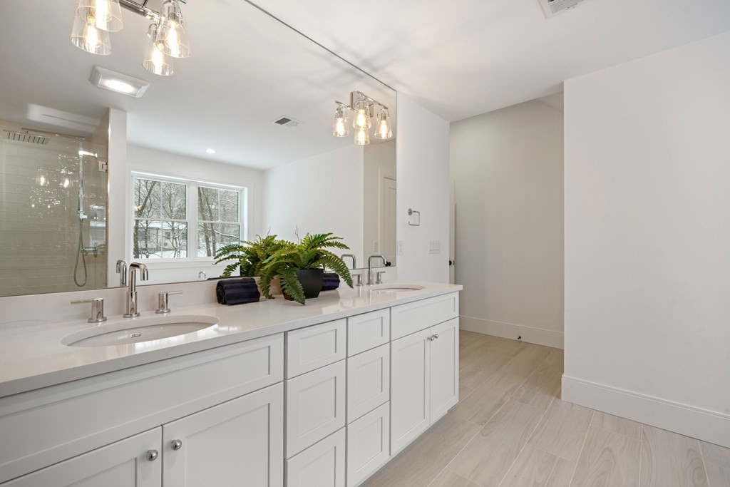 15 Peterson Road Natick, MA 01760 - Photo 24 of 27 a bathroom with a sink a potted plant and a mirror
