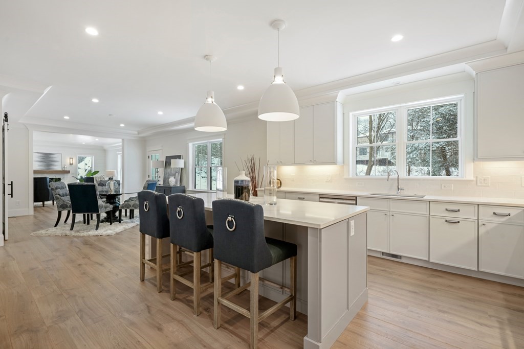 15 Peterson Road Natick, MA 01760 - Photo 4 of 27 a kitchen with a dining table chairs stainless steel appliances cabinets and a counter top space