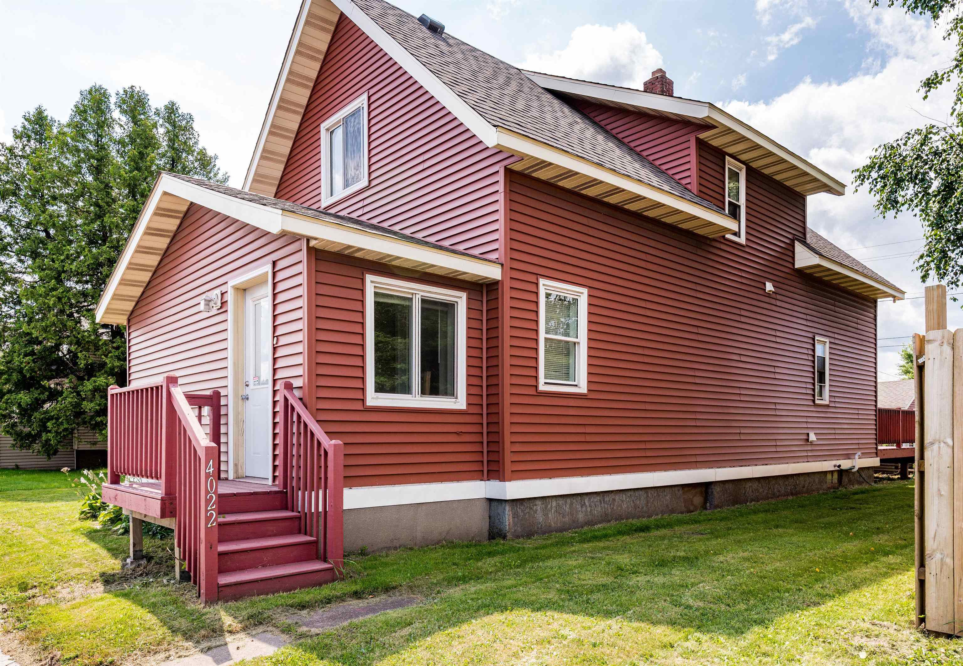 4022 East 2nd Street Superior, WI 54880 - Photo 1 of 30 View of home's exterior featuring a lawn, a shingled roof, and a chimney