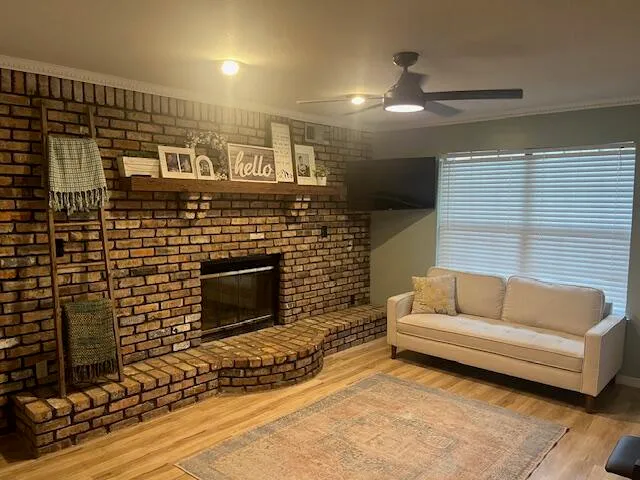 a living room with furniture a flat screen tv and a fireplace