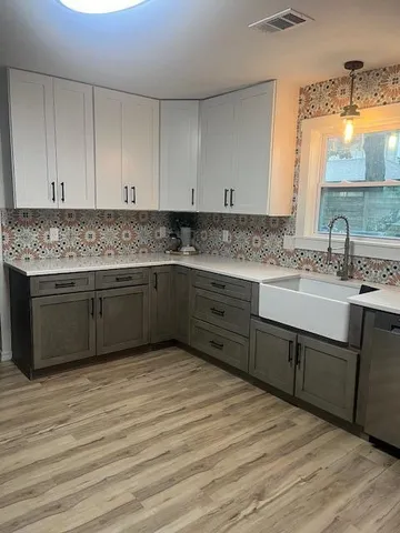 a kitchen with a sink cabinets and window