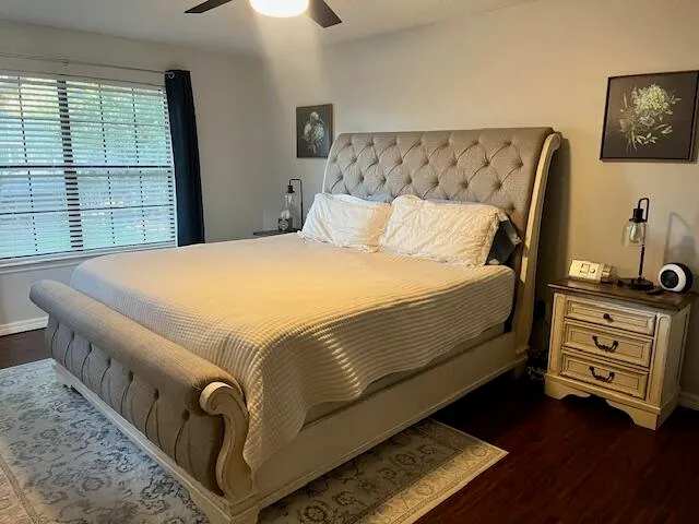 a bed sitting in a bedroom next to a window