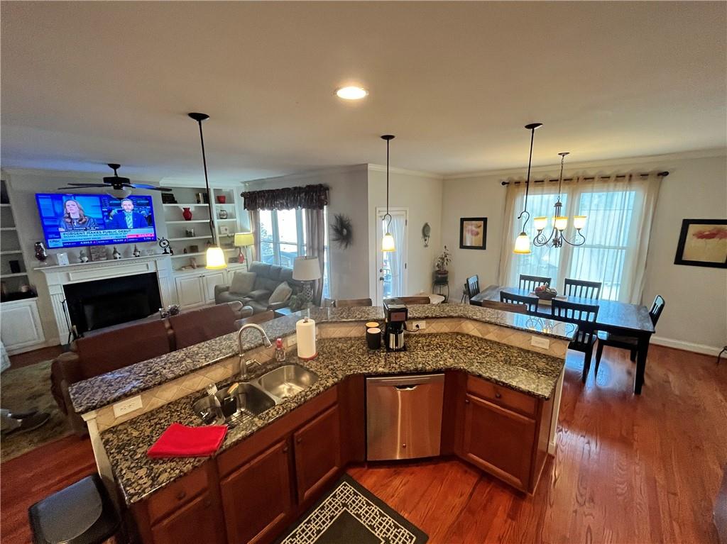 307 Cornerstone Trace Woodstock, GA 30188 - Photo 12 of 43 a kitchen with a refrigerator a stove a dining table and chairs with wooden floor