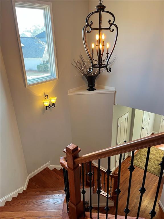 307 Cornerstone Trace Woodstock, GA 30188 - Photo 16 of 43 a view of a hallway with wooden floor and a chandelier