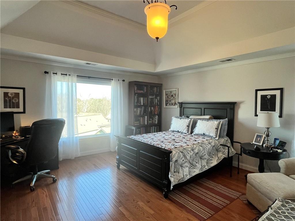 307 Cornerstone Trace Woodstock, GA 30188 - Photo 22 of 43 a bedroom with a bed and wooden floor
