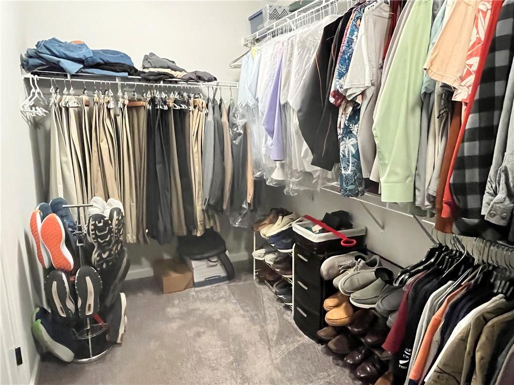 307 Cornerstone Trace Woodstock, GA 30188 - Photo 27 of 43 a view of walk in closet with clothes and shoes