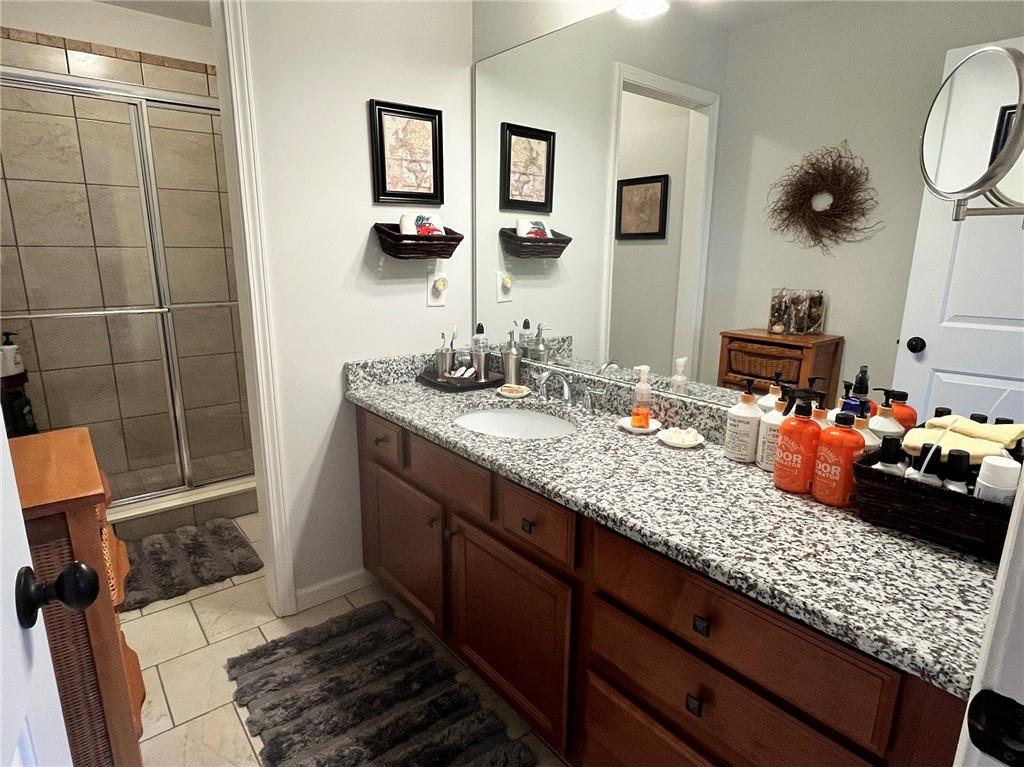 307 Cornerstone Trace Woodstock, GA 30188 - Photo 29 of 43 a bathroom with a double vanity sink and a mirror