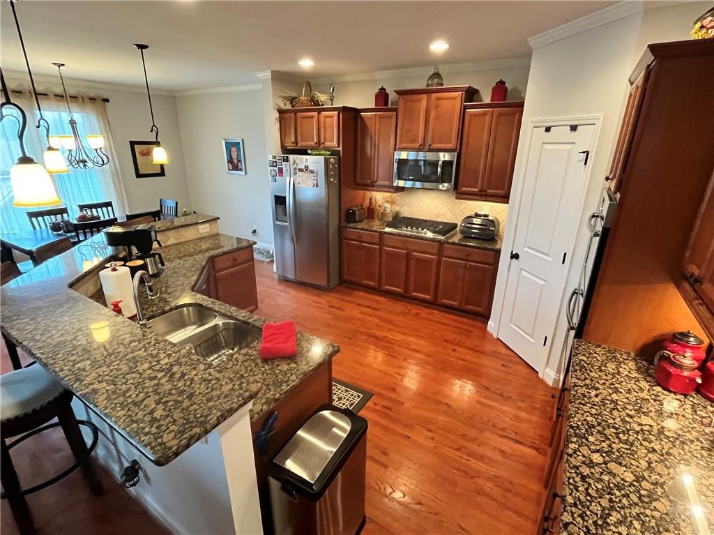 307 Cornerstone Trace Woodstock, GA 30188 - Photo 3 of 43 a kitchen with stainless steel appliances granite countertop a refrigerator stove and sink