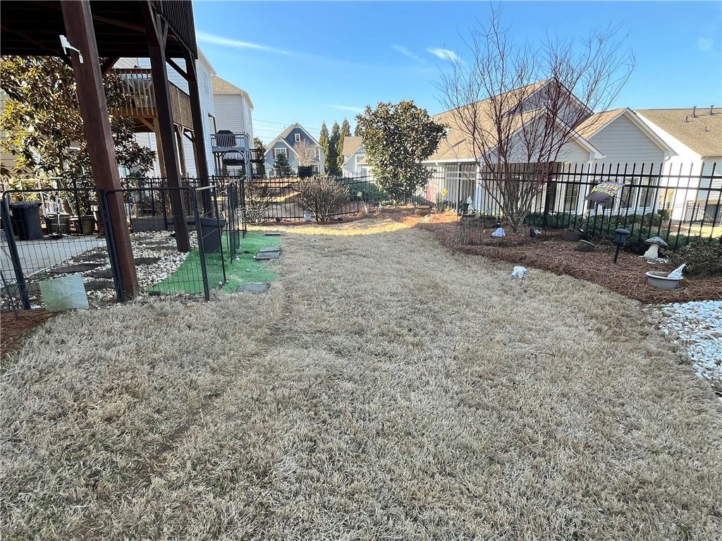 307 Cornerstone Trace Woodstock, GA 30188 - Photo 40 of 43 a view of a large house with a yard and wooden fence